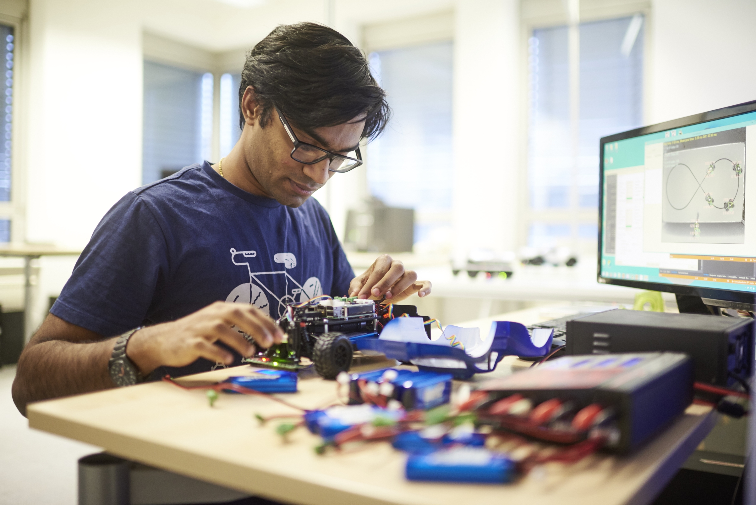 A man assembling an autonomous vehicle for wireless networks