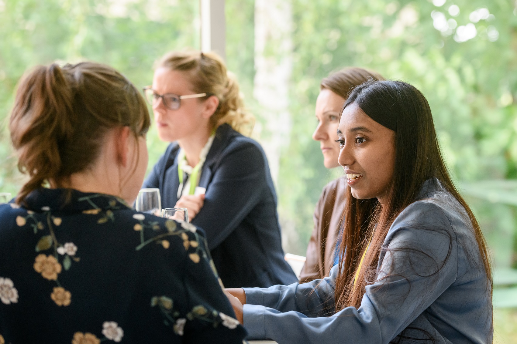 Four girls sitting and talking at a table