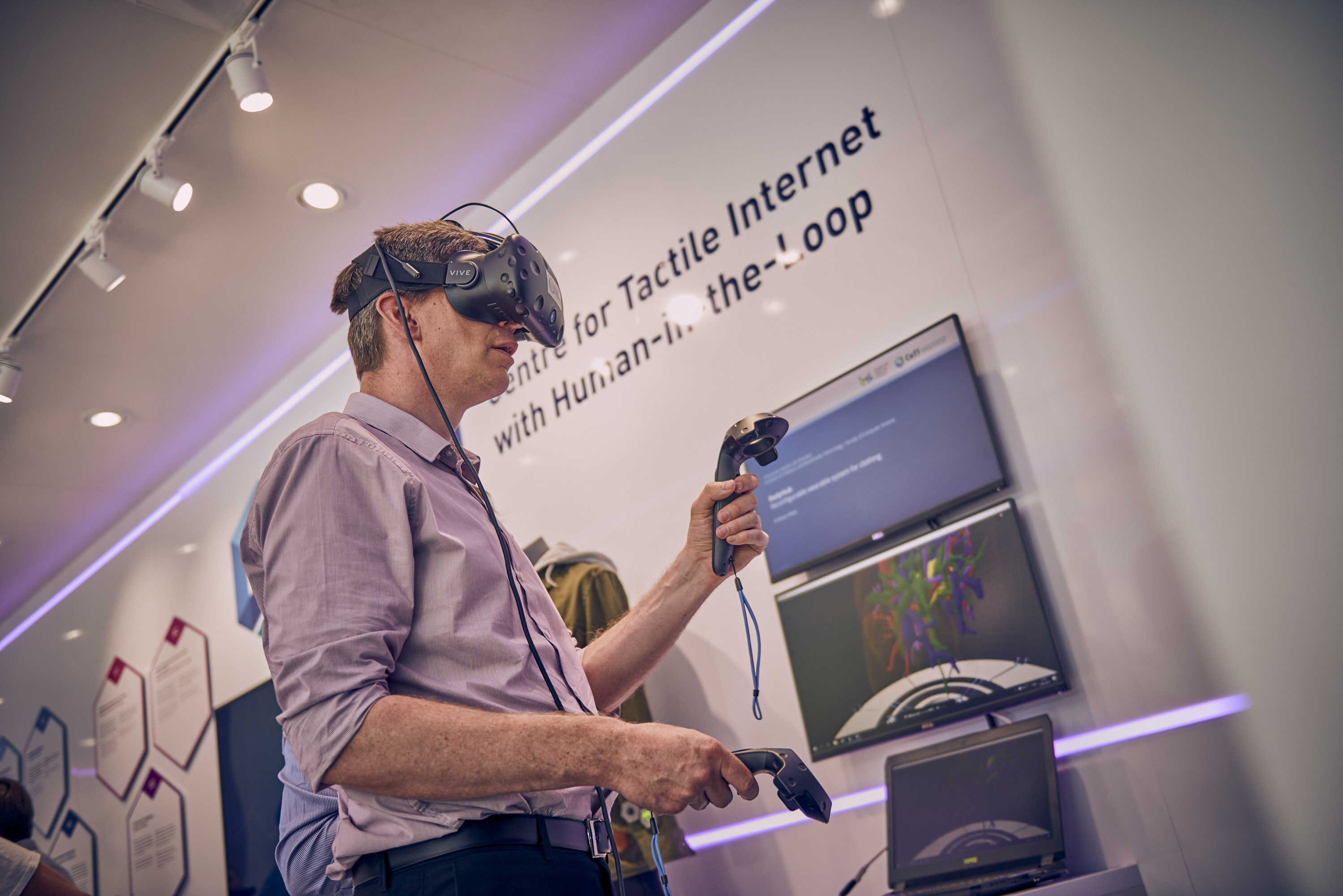 A man trying on a virtual reality visor and holding controllers